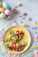 Funny chick egg omelette with ham vegetables for kids breakfast