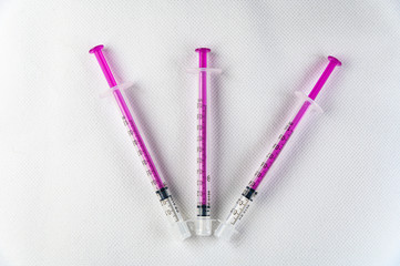 3 enternal low dose syringes on isolated white background