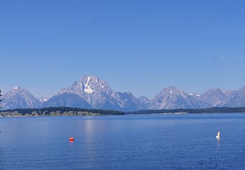 Panoramic view of Jackson Lake dam with  the Grand Teton mountain ranges in the background.