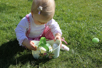 Little girl hunting for easter egg. Easter day.