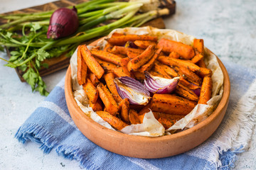 Baked, roasted or grilled carrot sticks with herbs and spices. Vegan food