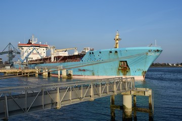 Oil Tanker ship in operation at the Petroleum products terminal of Lorient, France, with blue hull...