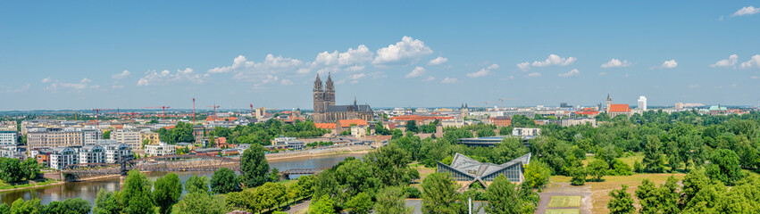 Fototapeta premium Panoramic bird view of Elbe river, old and new town, cathedral and city park in Magdeburg, Germany, summer, blue sky
