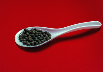 Black pepper on a red background