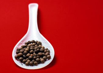Black pepper on a red background