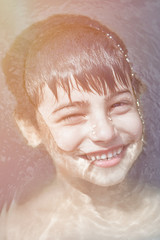 little boy in the water smiling concept of ecology and clean water