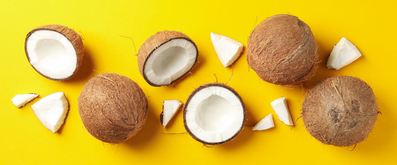 Flat lay with coconut on yellow background, top view