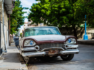 Old rusty American car parked on a street in Havana, Cuba