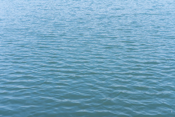 Sea surface of water with small waves from the wind