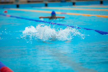 Water splash in swimming pool. Summer vacation holiday.