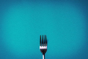Fork on blue background. Backgrounds for food