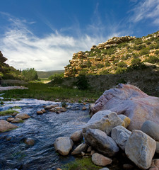 Mountain landscapes with river rocks and vegetation