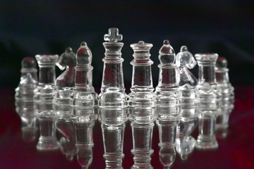 glass chess pieces on black background