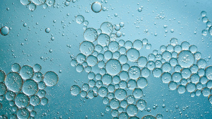 oil with bubbles on on dark blue background. Abstract background.