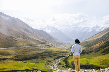 Girl looking at ravines along Duku Highway, China