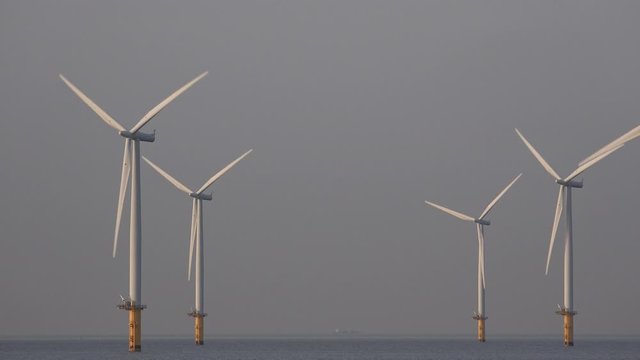 Offshore wind turbine farm off teesside North east England UK 4K