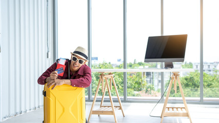 Company employees sit behind a yellow suitcase with a credit card and passport. For preparing to travel during the summer or weekend.summer concept