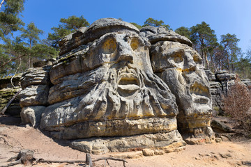 Obraz premium Devil's heads, monument sandstone sculptures from 19th century in northern Bohemia, Zelizy, Czech Republic