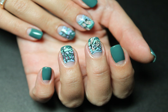 Summer bright moon manicure with marine design colored gel paint drawn by hand the hands of a fashionable modern woman