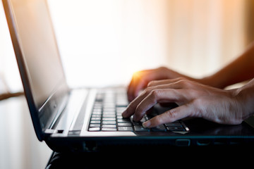 Woman using finger press the keyboard on laptop for working. Concept of Work at home.