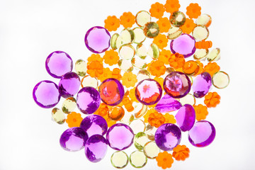 A collection of colourful beads in purple, orange, and green.