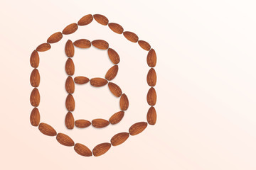 Letter B of the English alphabet from nuts in hexagon shape. Food pattern made from nuts alphabet for shop and diet