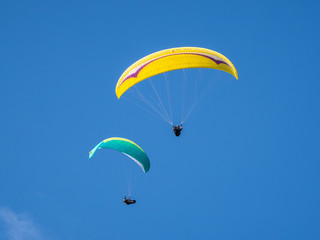 Paragliders fly from the Litlington White Horse, a monument in the Cuckmere Valley, East Sussex, England.