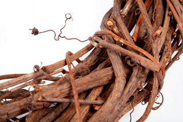 Wicker wreath from a rod of a vine close-up. Texture and background image on a white background. Handmade from natural material.