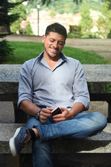 Obraz premium Handsome Guy with his Phone in a Park