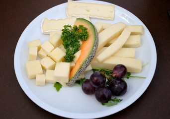 Cheese plate with a slice of melon and grapes in Cologne, Germany