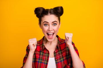 Photo of pretty crazy lady two cute buns yelling watch sports game match raise fists cheerleader support favorite team wear casual plaid shirt isolated yellow color background