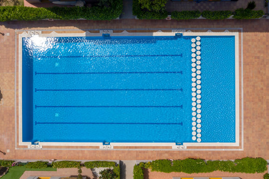 Aerial drone top-down photo of an Olympic sized leisure swimming pool located in a private residential area in spain