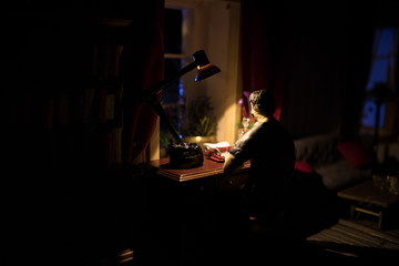 A realistic dollhouse living room with furniture and window at night. Artwork table decoration with handmade realistic dollhouse.