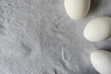 White eggs on paper background, copy space.