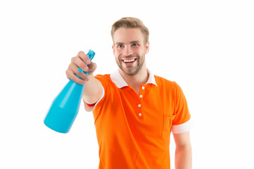 My reputation is spotless. Happy guy spray household cleaner. Handsome man hold bottle with...