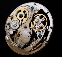vintage watch mechanism  over black surface macro detail