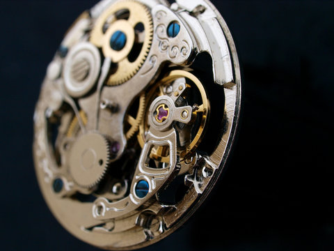 vintage watch mechanism macro detail over black surface