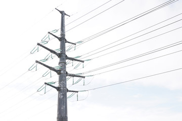 high voltage pole with voltage in an open field.