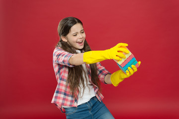 Housekeeping duties. Wash dishes. Turn cleaning into game. Inculcate cleanliness. Cleaning with sponge. Cleaning supplies. Girl rubber gloves for cleaning hold colorful sponges. Cleaning could be fun