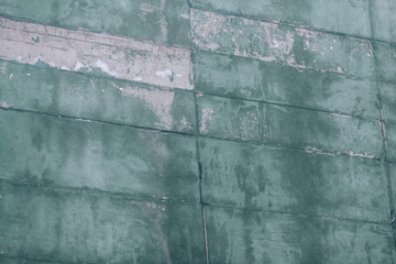 Green concrete wall. Old industrial building, wall of concrete blocks in green