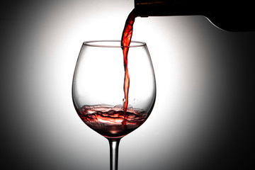 red wine pouring into glass