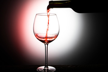 red wine pouring into glass