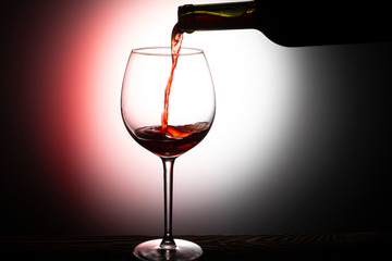 red wine pouring into glass