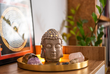 Buddha head with crystals. Balance and calm energy flow in home.