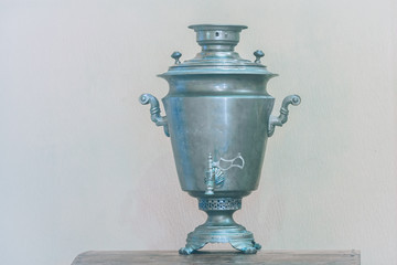 Antique copper samovar, a concept with antique dishes in vintage colors.
