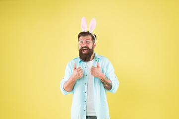 Naklejka premium Sincere recommendation. Man long rabbit ears. Bearded man Easter rabbit costume. Easter bunny or hare. Hipster dressed for Easter party. Easter bunny symbol of fertility and spring. Having fun