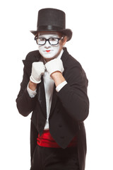 Portrait of male mime artist performing, isolated on white background. Mime in a stand ready to box. Symbol of fight, win, compete