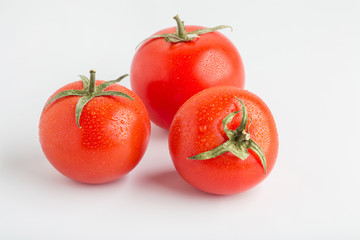 Beautiful juicy red tomatoes on a white background