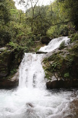 Beautiful landscape of a waterfall in a forest in a Mountain in Sichuan, China