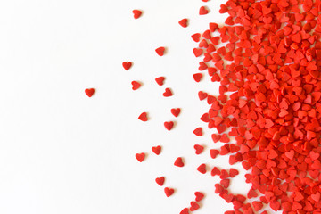 Minimalistic background for valentine's day with wavy little hearts on a white background. top view.